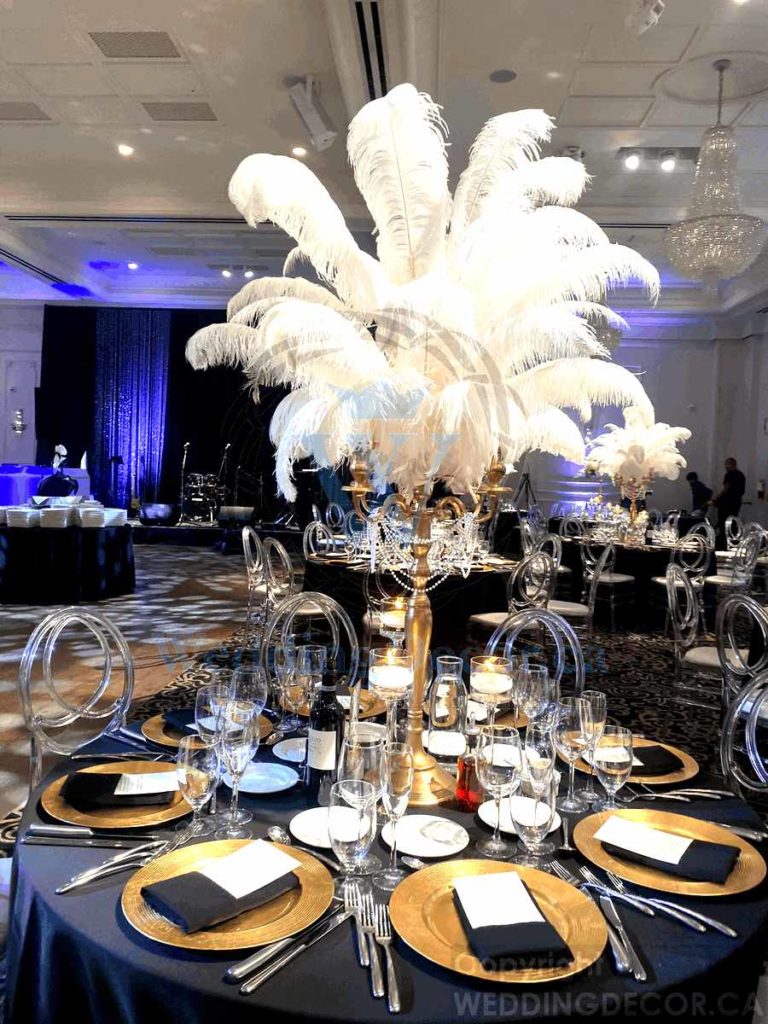 Wedding Decor Toronto centerpiece rentals tall clear curvy vase with white large ostidge feathers 768x1024